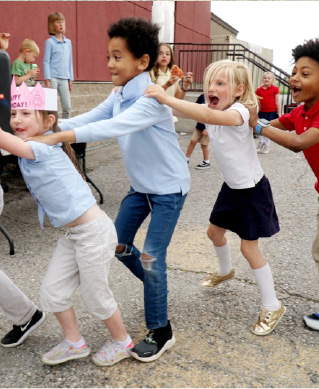 kids dancing playing and smiling together
