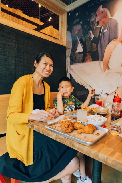 mom and son smiling enjoying a meal at crack shack