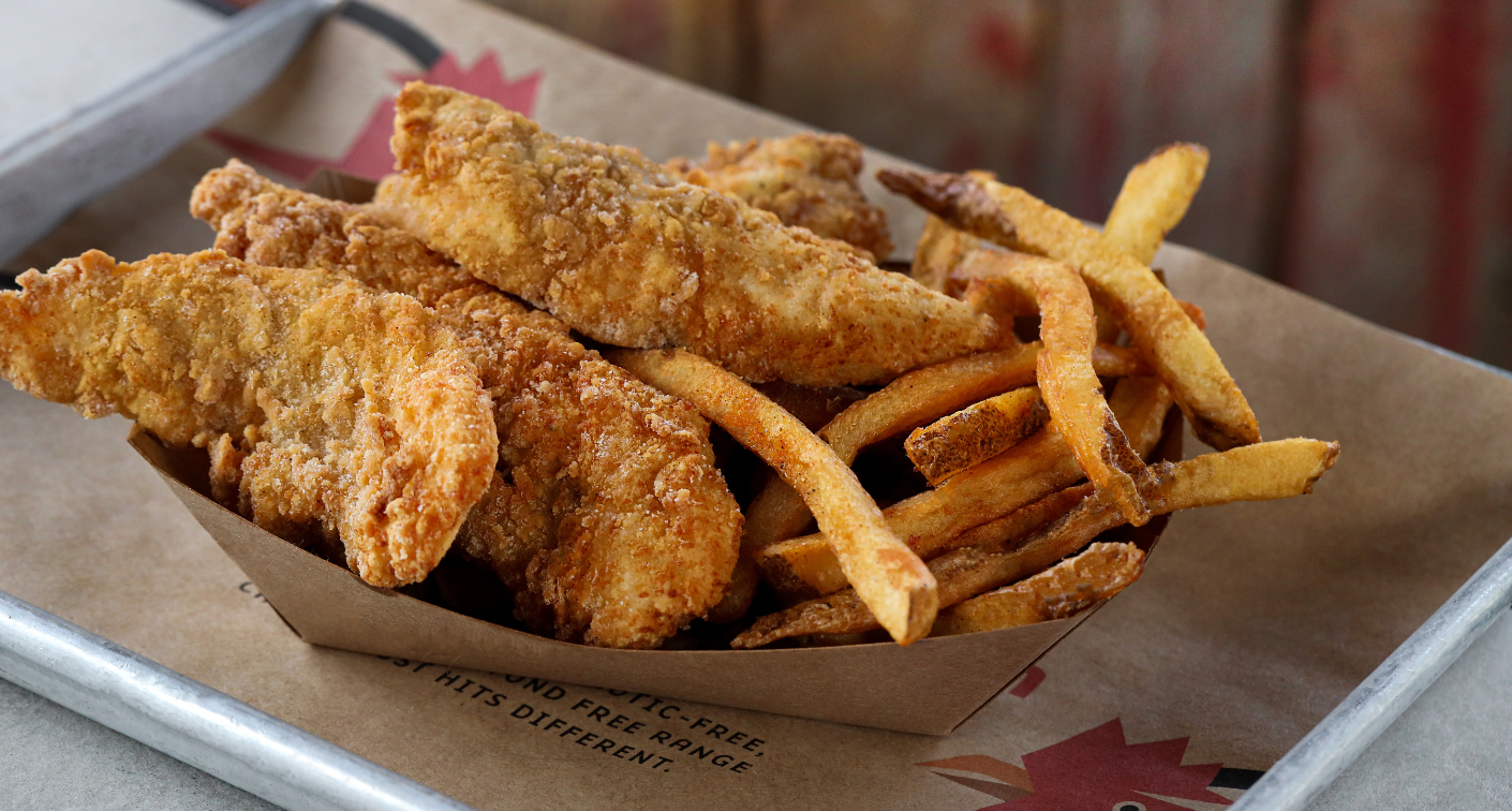 Tray of chicken tenders and fries in a boat