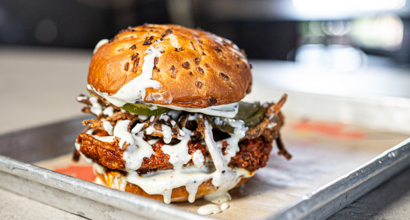 Spicy chicken sandwich drizzled with ranch.