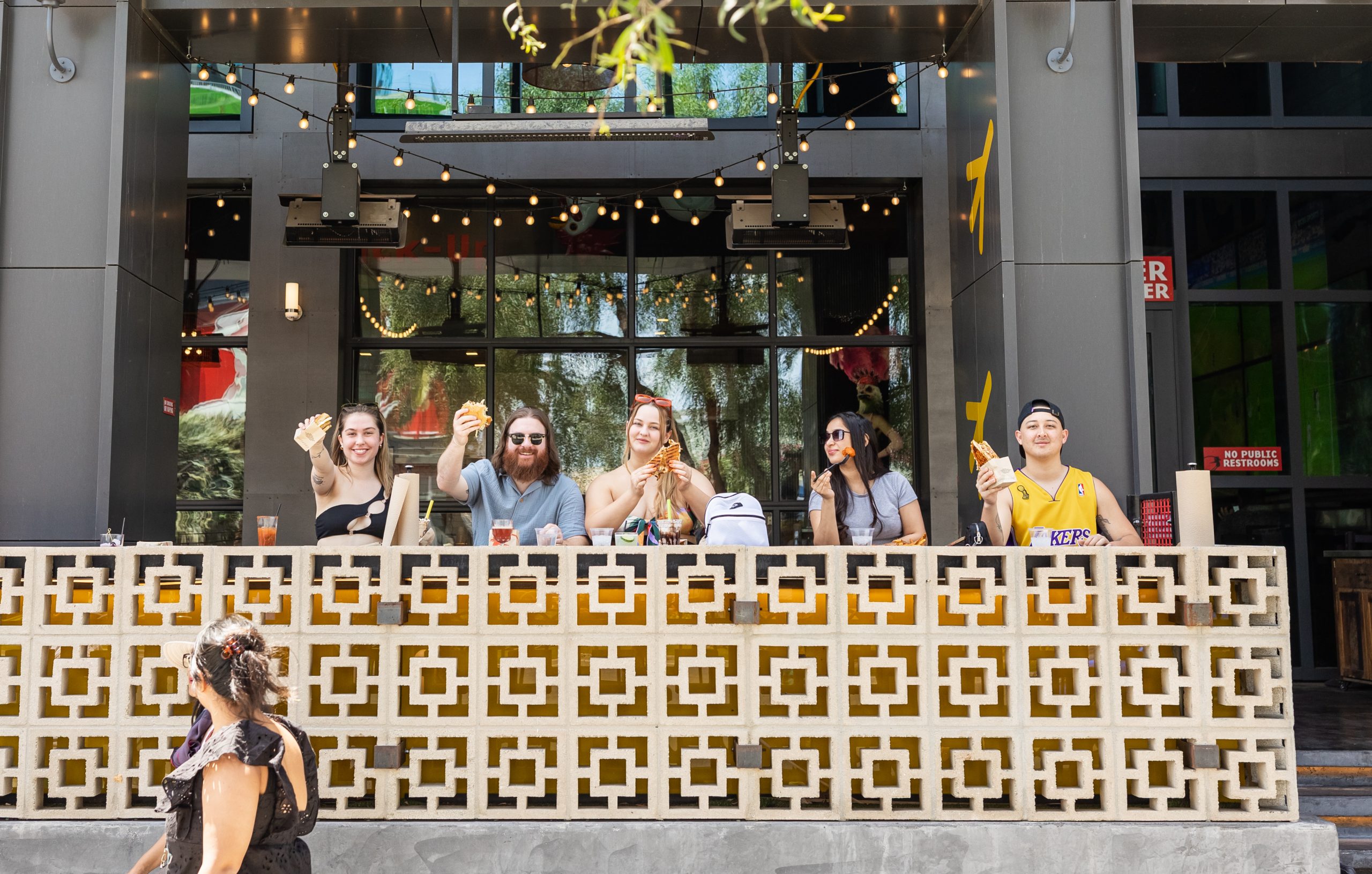 Group of people sitting at a restaurant eating sandwiches