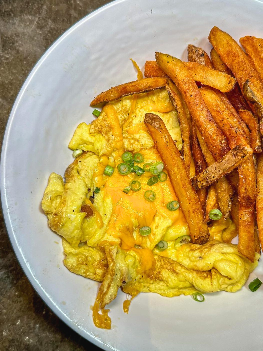 Scramble next to french fries in a bowl