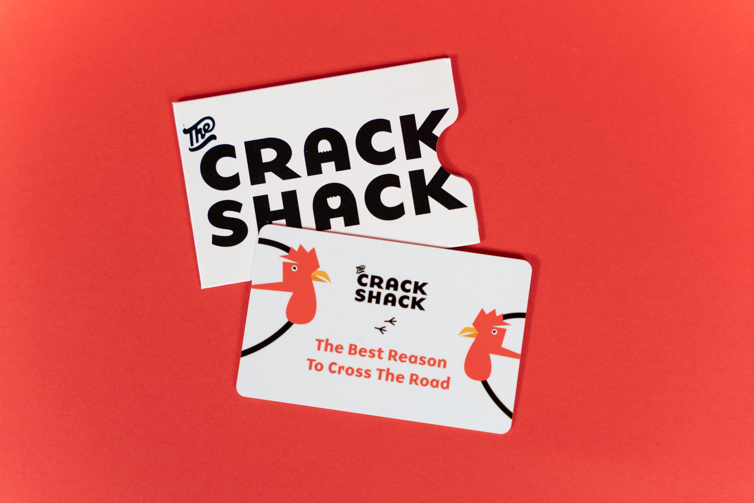 Gift card and holder with a red background.