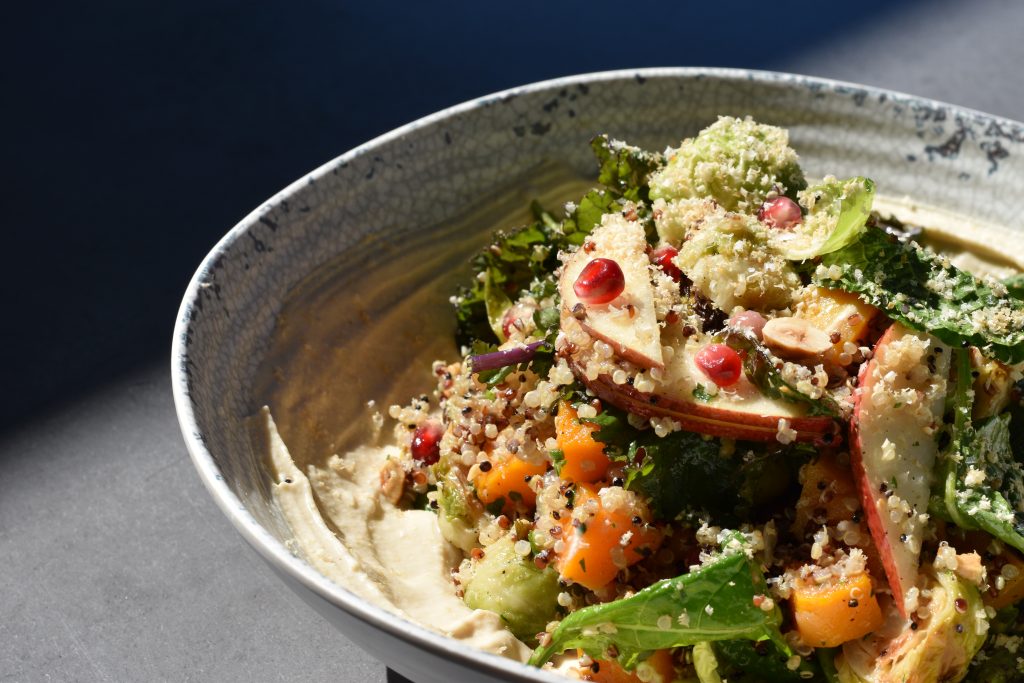 Bowl of fall vegetables, quinoa, and hummus.
