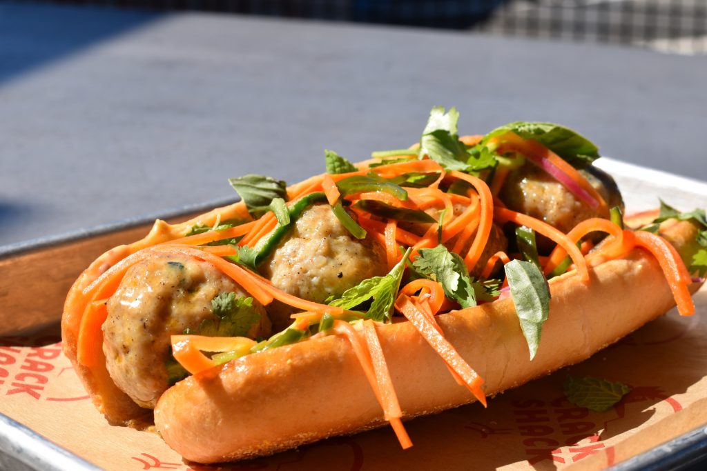 Bread roll with meatballs, pickled veggies, and mayo.