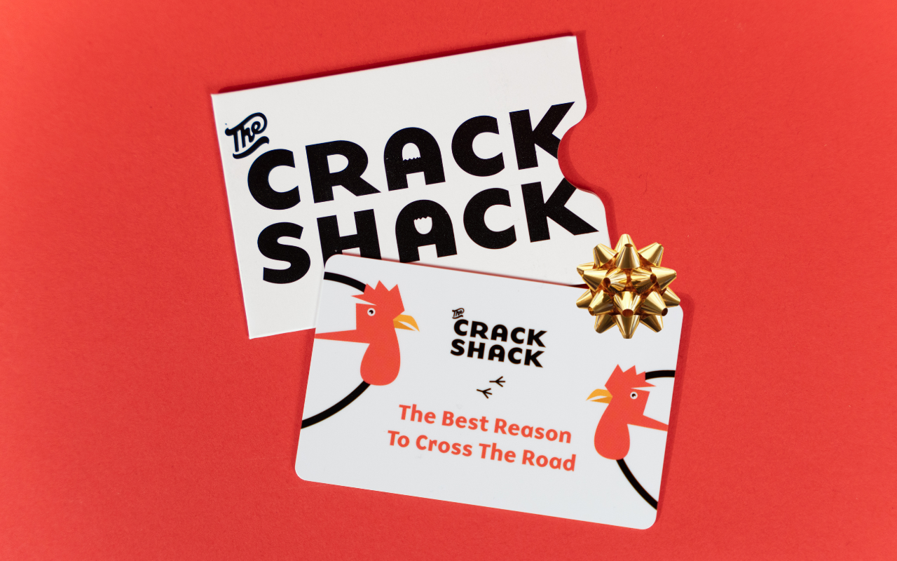 Crack Shack gift crd with a bow on a red background.