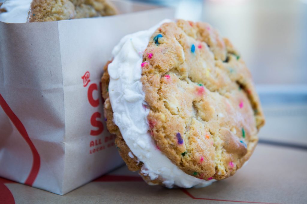 Birthday cake cookie ice cream sandwich on tray.